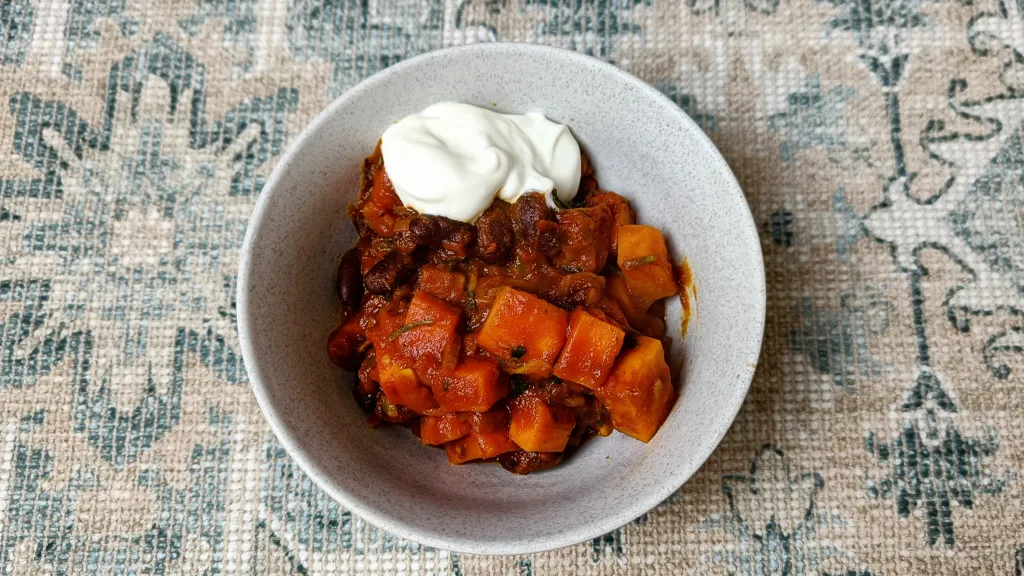Photograph of Red kidney bean & sweet potato stew with yogurt & hot mint oil.