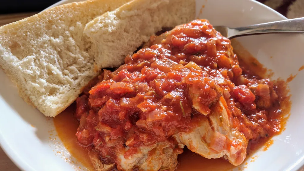 Photograph of Rosemary chicken with tomato sauce.