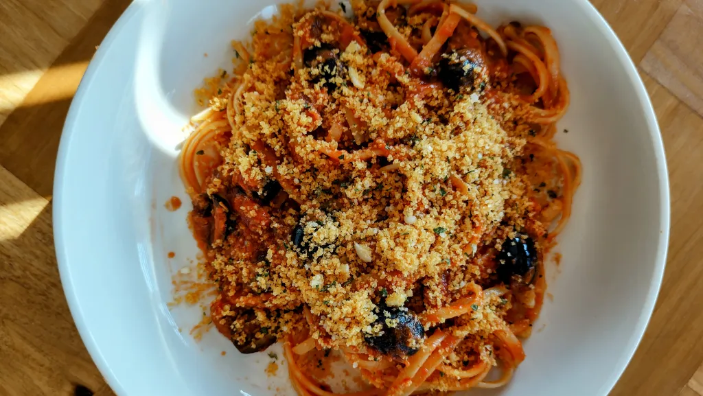 Photograph of Sardine pasta with crunchy parsley crumbs.