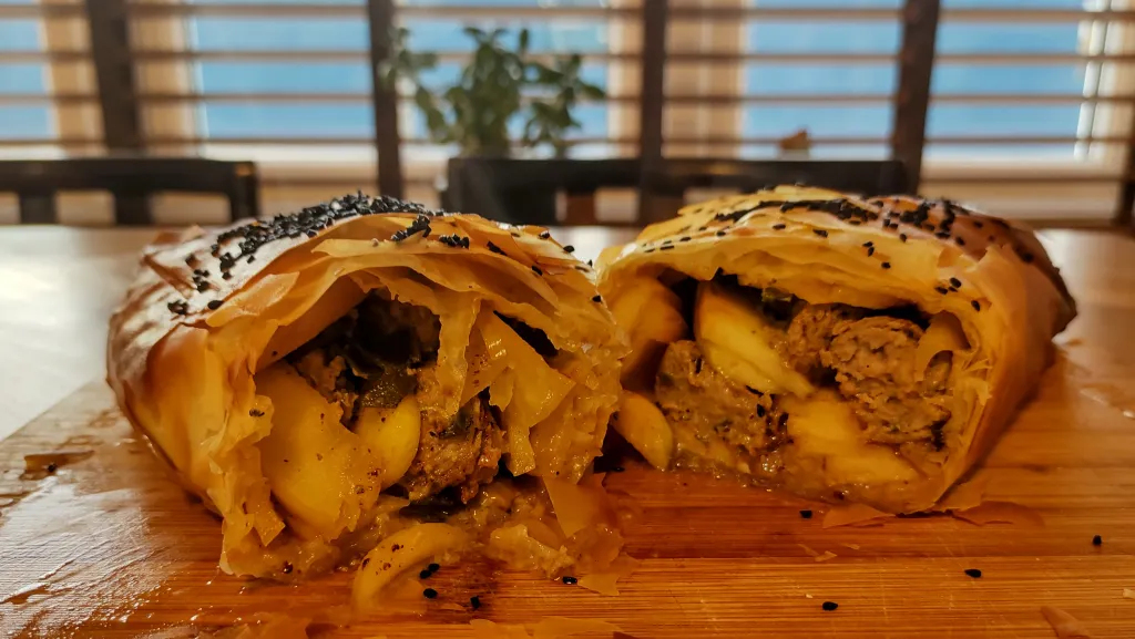 Photograph of Sausage, apple and stilton strudel.