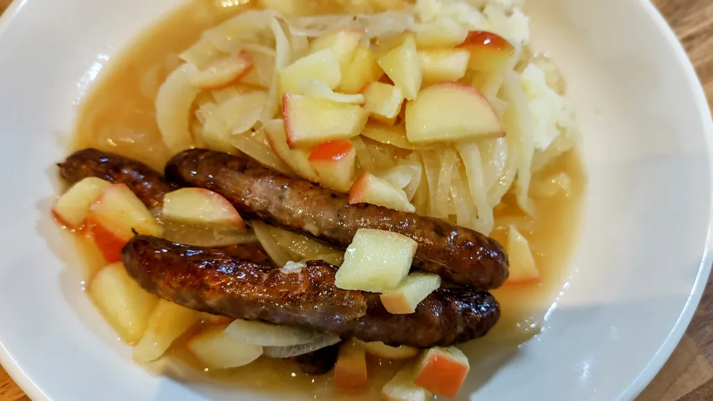 Photograph of Sausages with parsnip and apple mash.