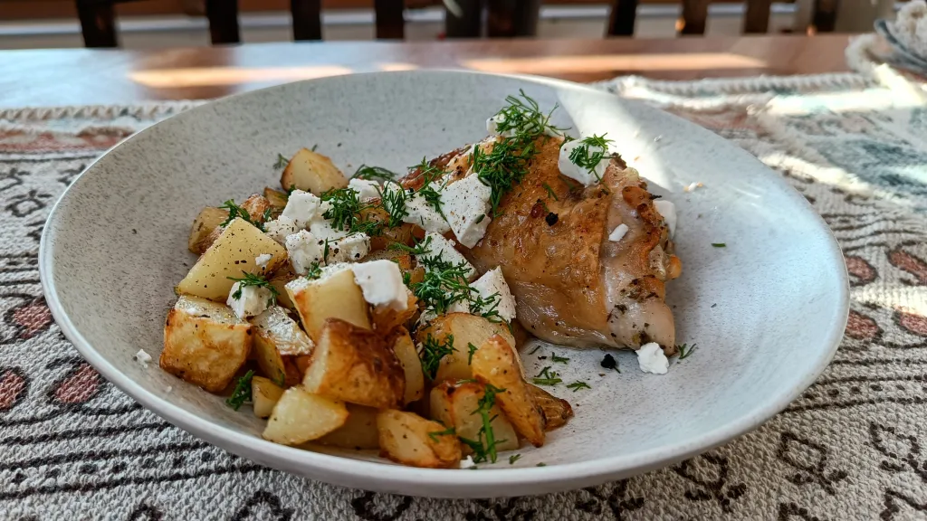 Photograph of Sheet-pan chicken and potatoes with feta, lemon and dill.