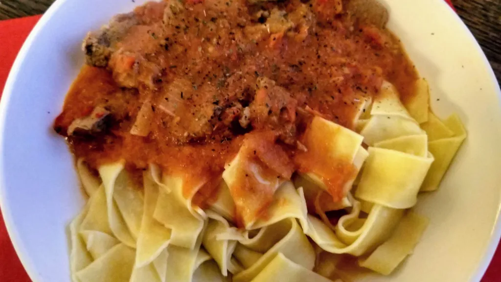 Photograph of Sicilian lamb with noodles.