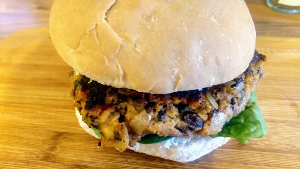 Photograph of Smoky black bean and sweet potato vegan burgers.