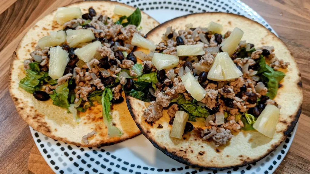 Photograph of Smoky pork and pineapple tostadas.