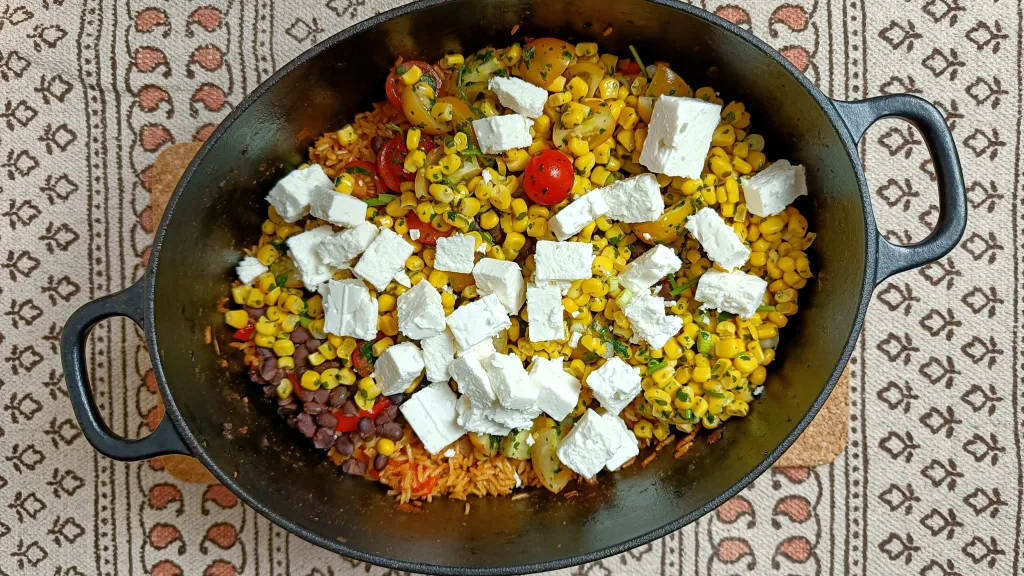 Photograph of Smoky rice with black beans, feta, corn & salsa.