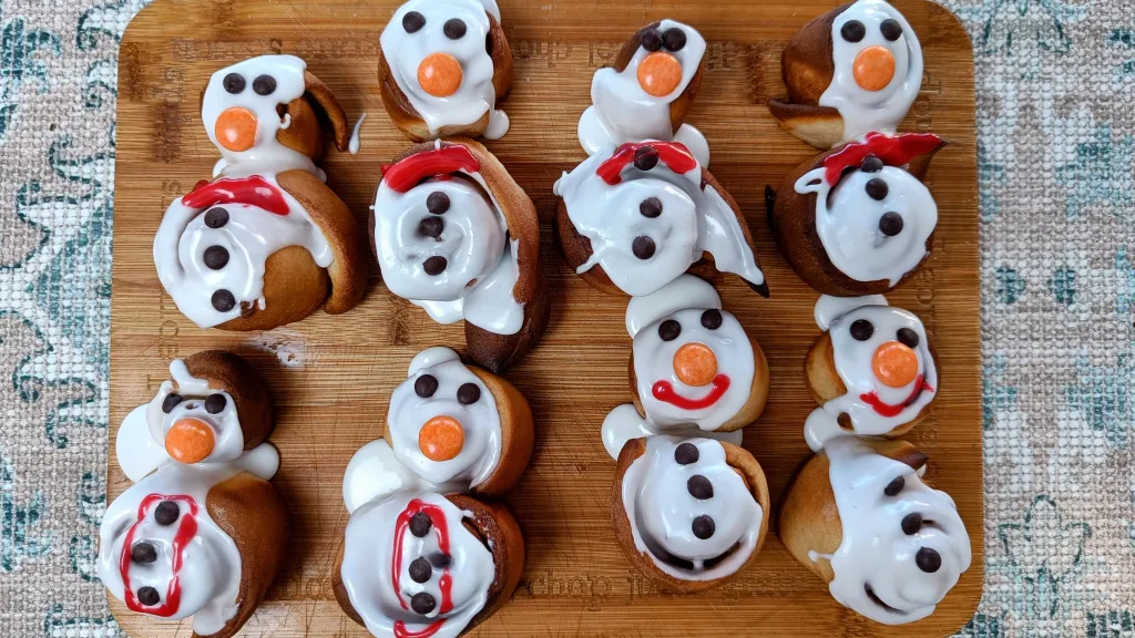 Photograph of Snowman cinnamon rolls.