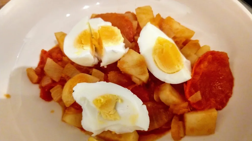 Photograph of Spiced potatoes and tomatoes.