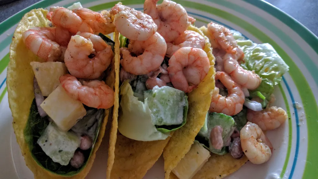 Photograph of Spicy jerk prawn & mango tacos with coconut dressing.