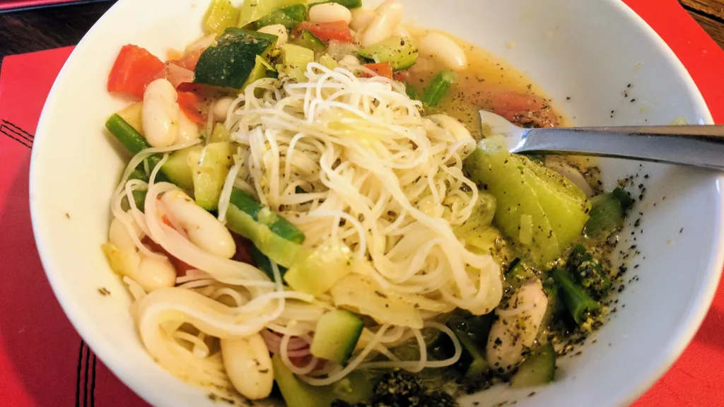 Photograph of Spring vegetable soup with basil pesto.