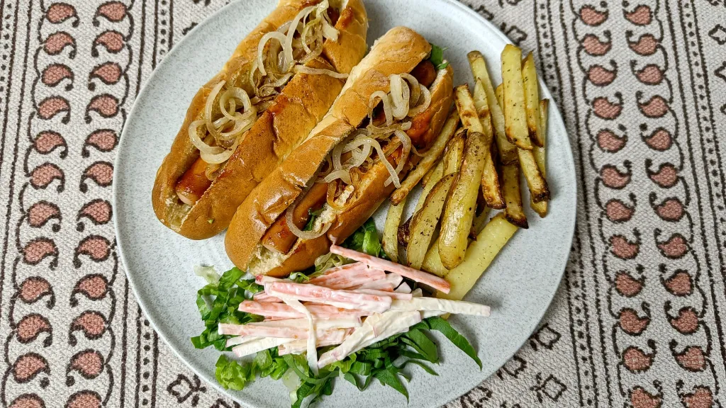 Photograph of Sticky honey mustard posh dogs with chips.