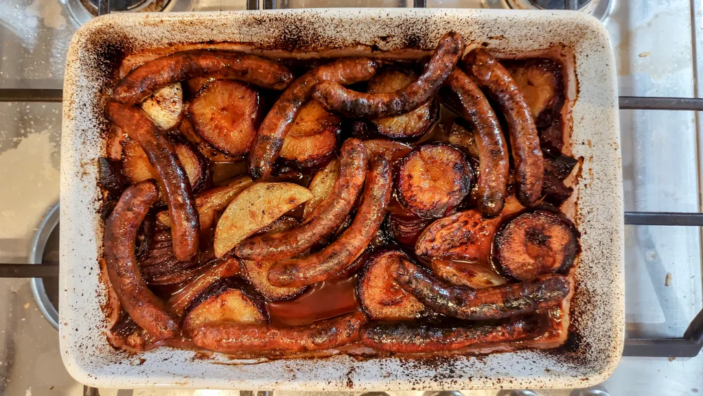 Photograph of Sticky sweet and sour plums and sausages.