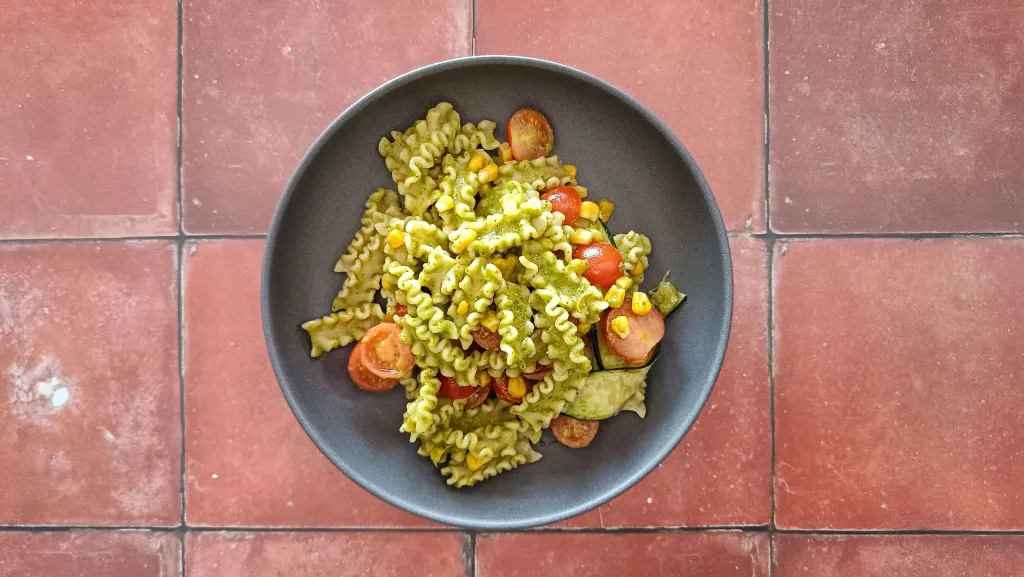 Photograph of Summer pasta salad with corn, zucchini, and basil vinaigrette.