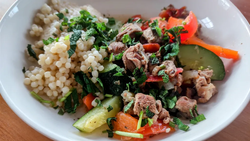 Photograph of Summer tagine of lamb, courgettes, peppers and mint.