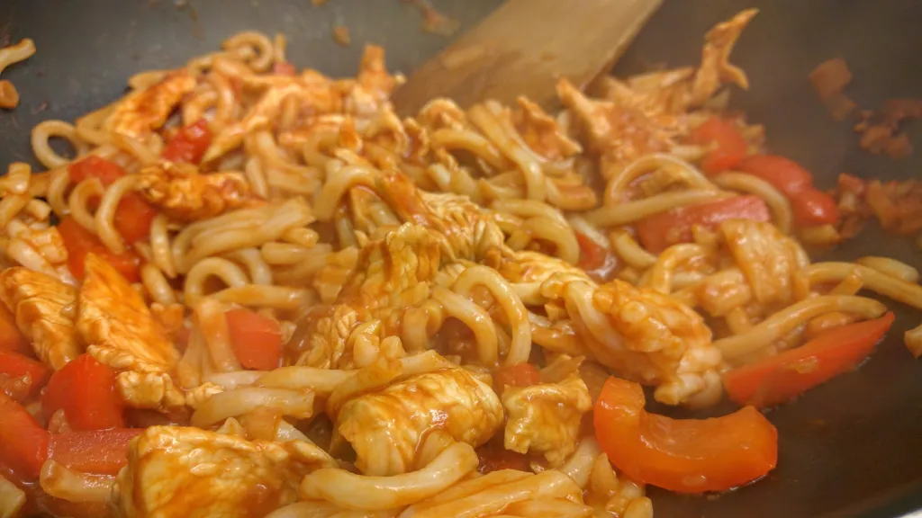 Photograph of Sweet and sour chicken noodles.