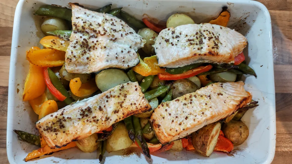 Photograph of Sweet mustard salmon with garlicky veg.