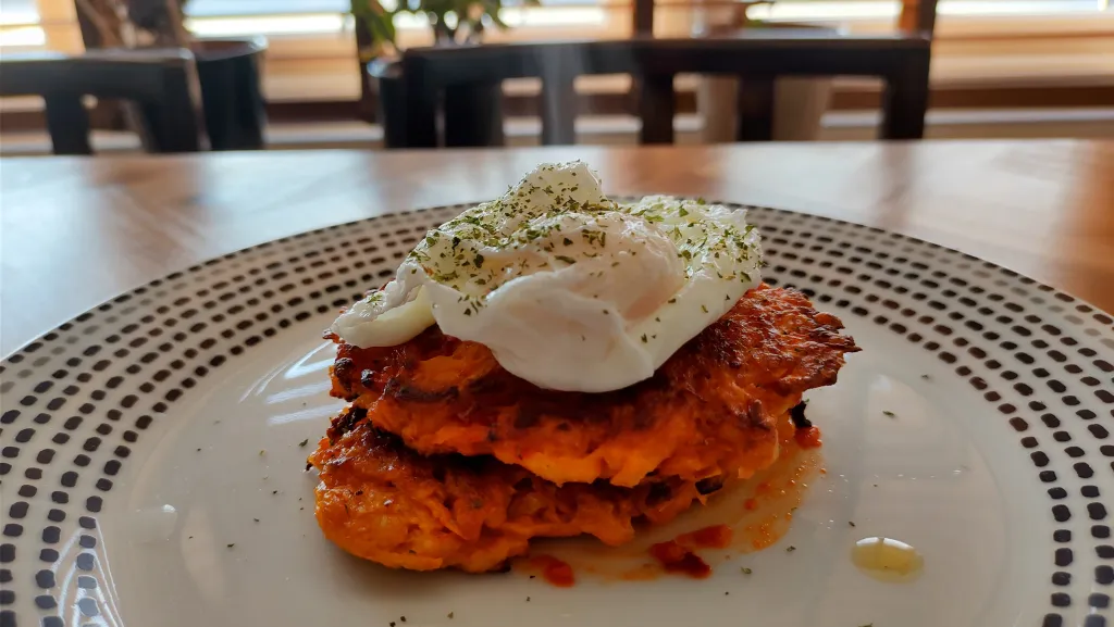 Photograph of Sweet potato cakes with poached eggs.