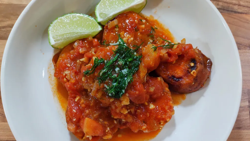 Photograph of Sweet potato in tomato, lime and cardamom sauce.