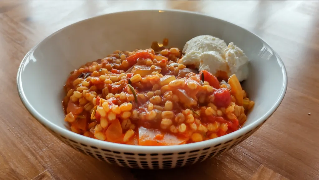 Photograph of Tomato and rosemary pearl barley risotto.