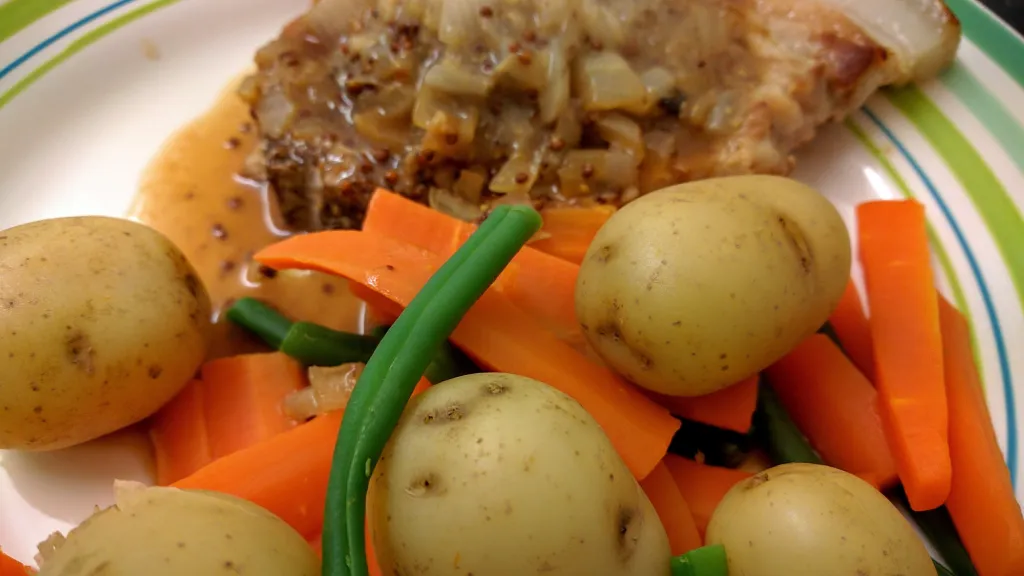 Photograph of Traditional pork steaks with honey and mustard sauce.