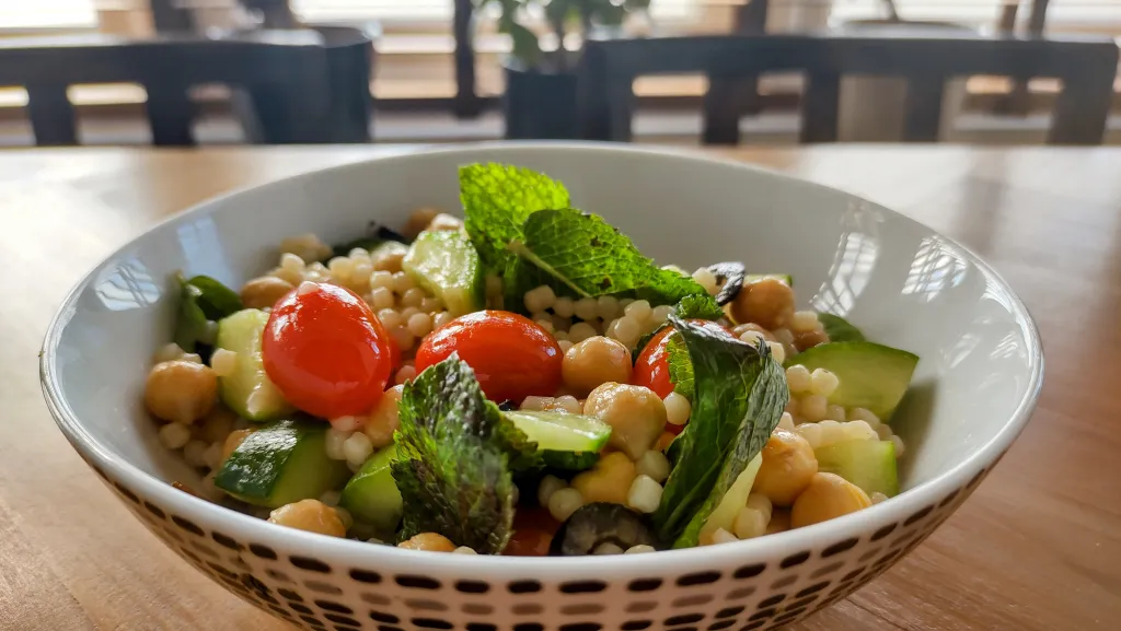 Photograph of Warm pearl couscous salad.
