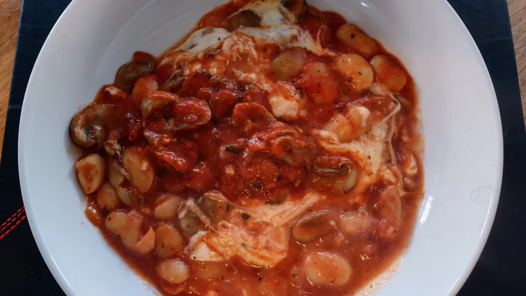 Photograph of White beans with mushrooms and marinara.