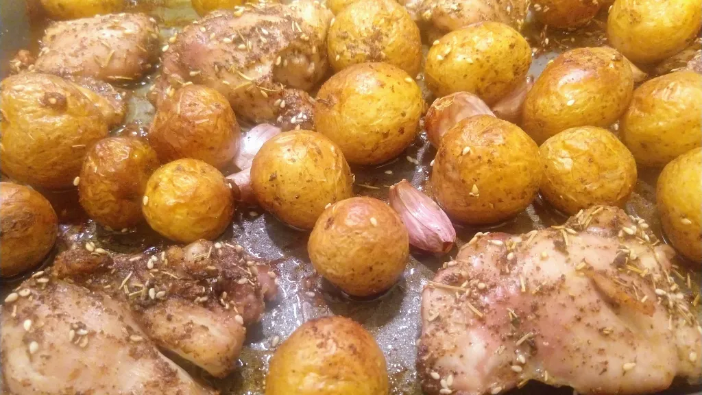 Photograph of Za'atar chicken & new potato bake with tzatziki.