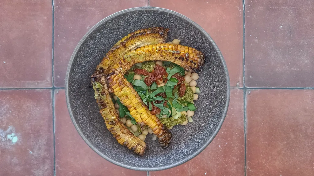 Photograph of Zucchini noodle bowl with walnut-kale pesto.